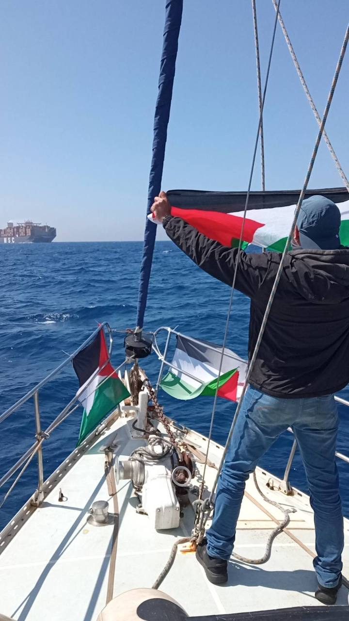 Raising the Palestinian flag as the MSC Maya looms on the horizon